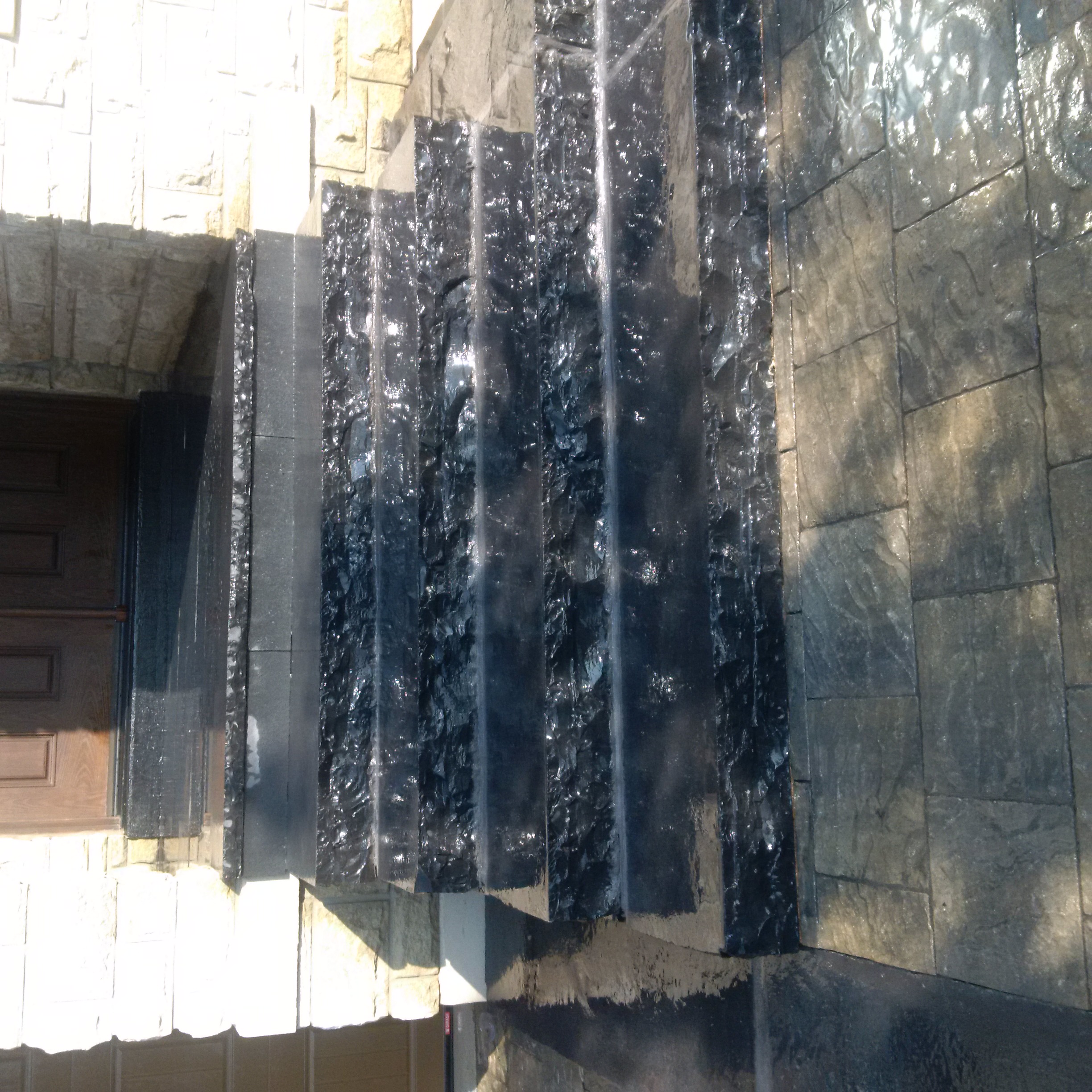 Stone water feature by Total Landscaping Services in Oakville