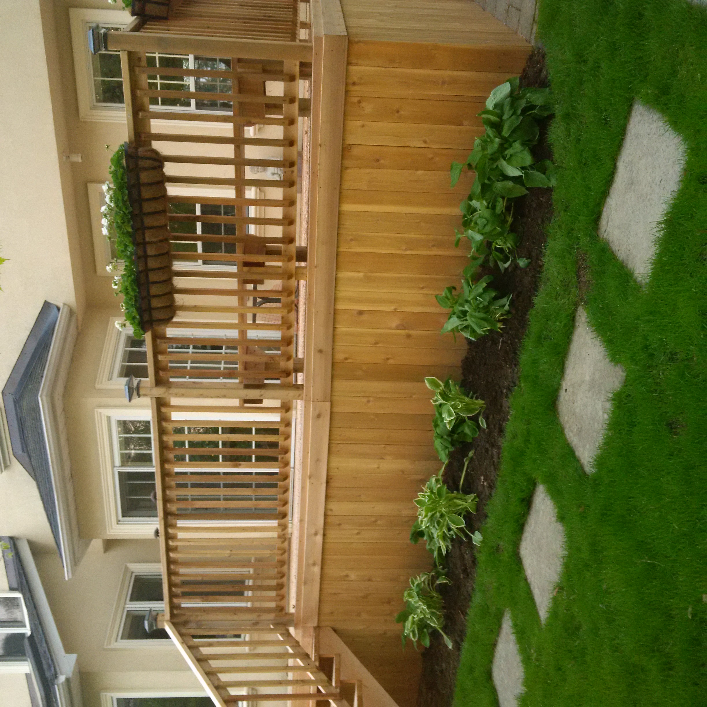 Deck with pergola by Total Landscaping Services